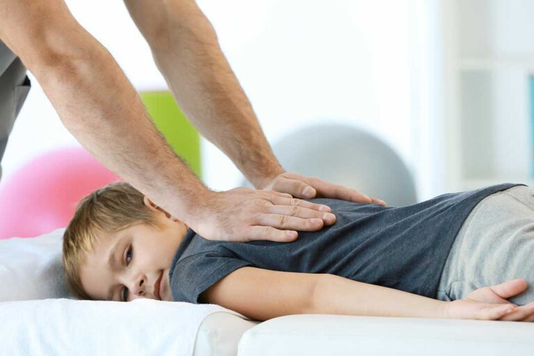 An older adult receiving a gentle wellness check from a healthcare provider in a calm, bright clinic setting.